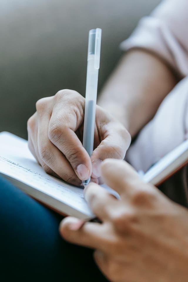 Person writing in notebook